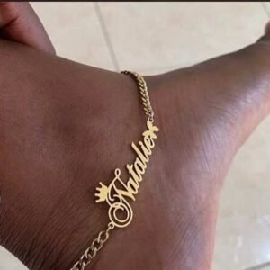 Custom name anklet in gold with the name Natalie, worn on the ankle